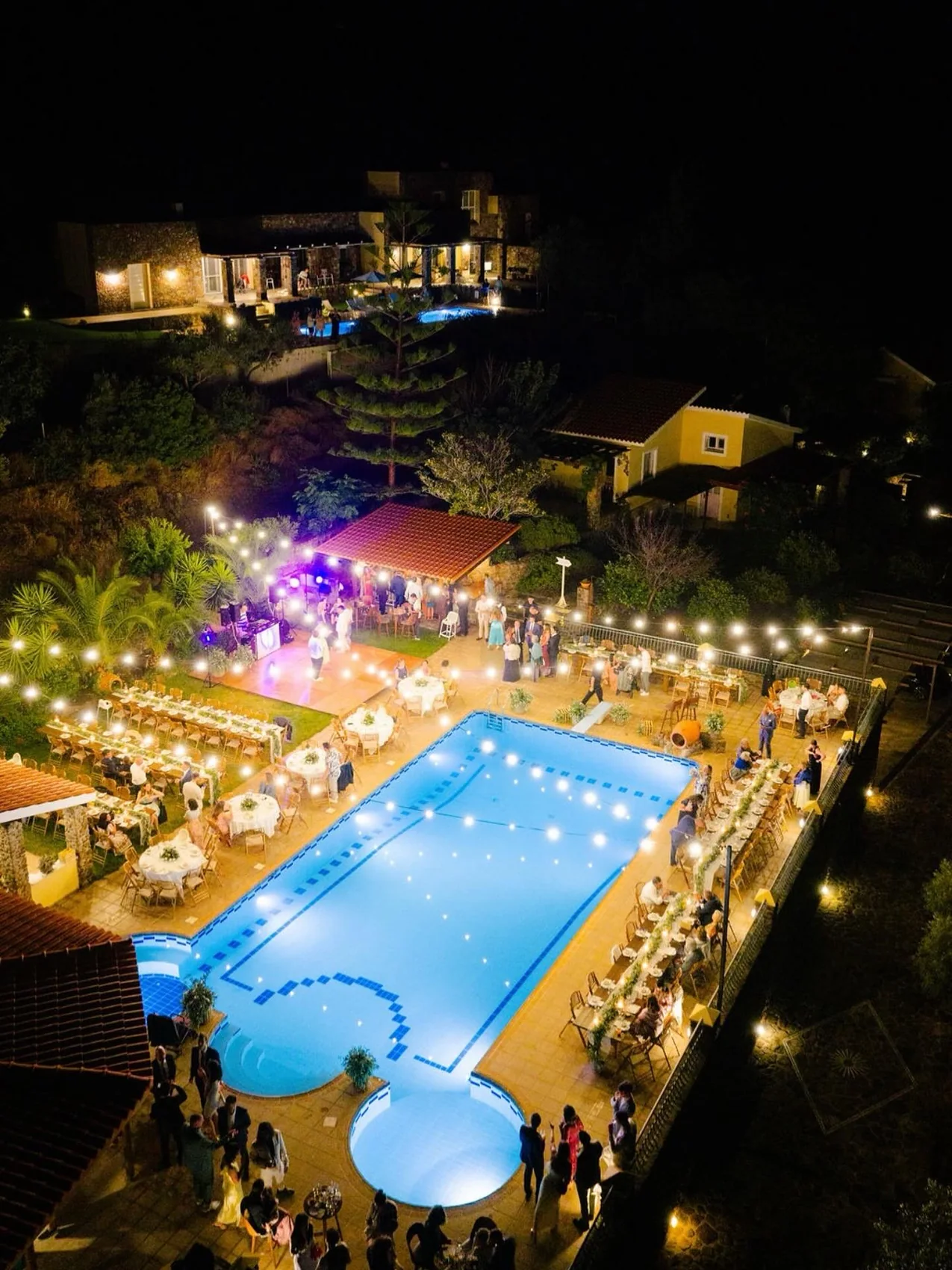 The reception at Villa Aelia seen from above, tables around the lit pool