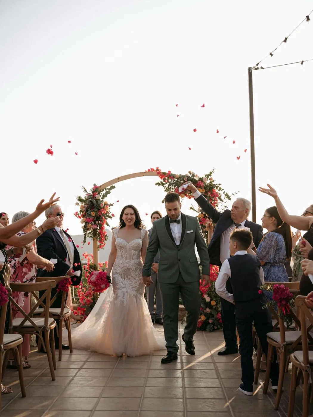 The couple walking back down the aisle at Villa Aelia