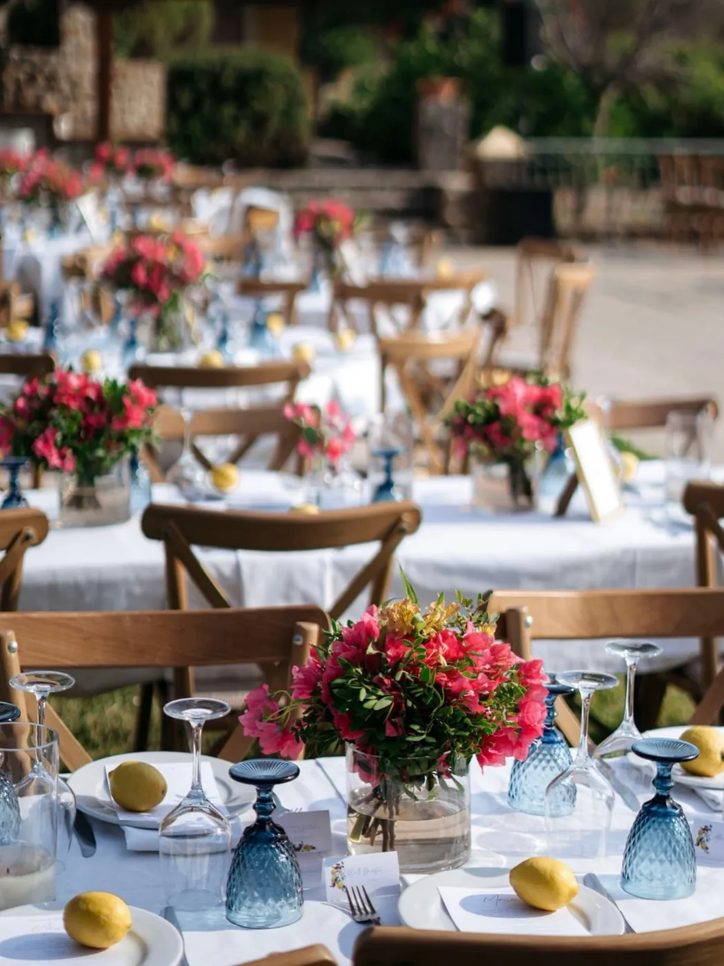 Round tables set with bougainvillea and lemons on the terrace
